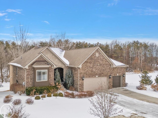 view of front of home featuring a garage and brick siding