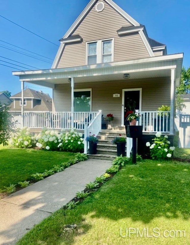 view of front of house featuring covered porch and a front lawn