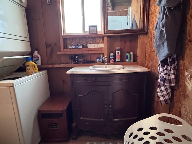 bathroom with vanity and stacked washing maching and dryer