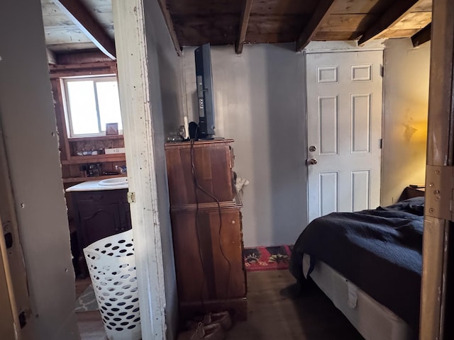 bedroom featuring beamed ceiling and sink