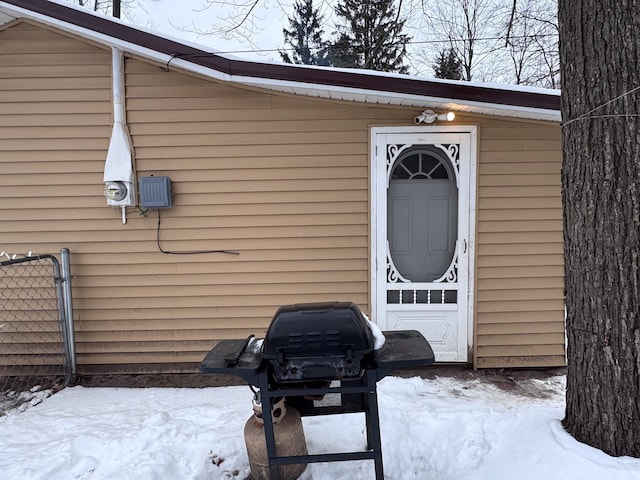 view of snow covered property entrance