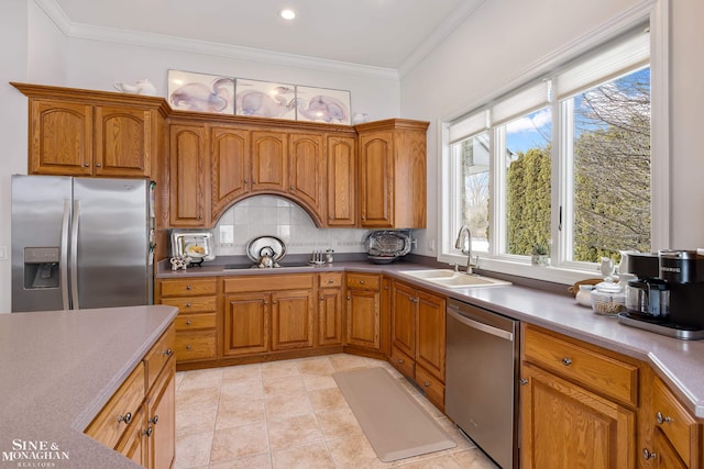 kitchen with tasteful backsplash, sink, ornamental molding, light tile patterned floors, and stainless steel appliances