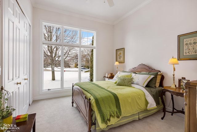 bedroom with crown molding, light colored carpet, and ceiling fan