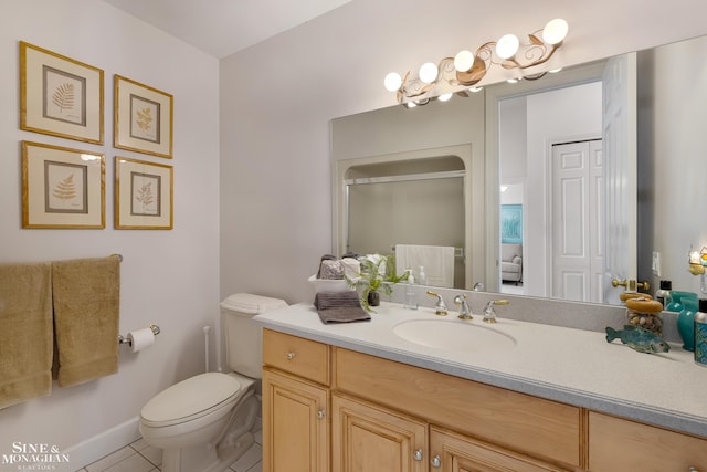 bathroom with vanity, toilet, and tile patterned flooring