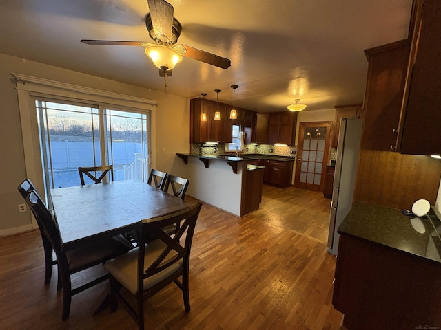 dining room featuring ceiling fan and dark hardwood / wood-style flooring