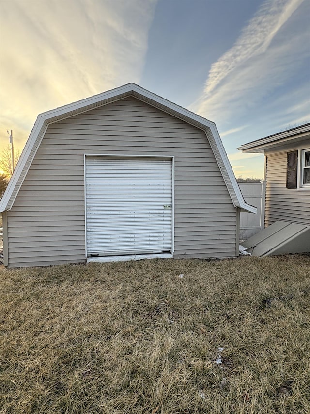 garage at dusk with a yard