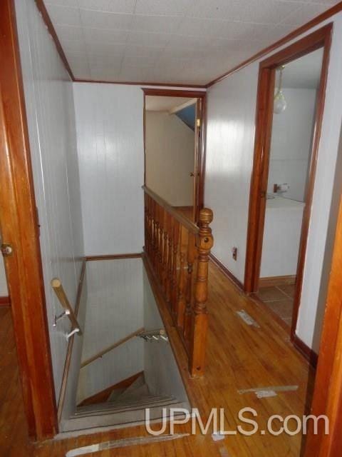 stairs featuring hardwood / wood-style flooring