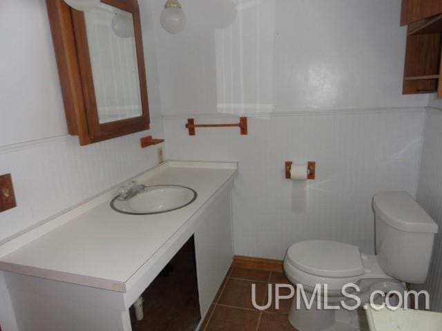 bathroom with tile patterned floors, toilet, and sink