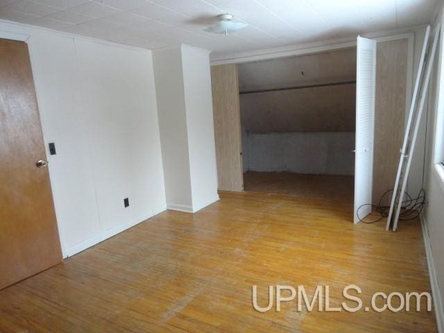 unfurnished room featuring hardwood / wood-style flooring