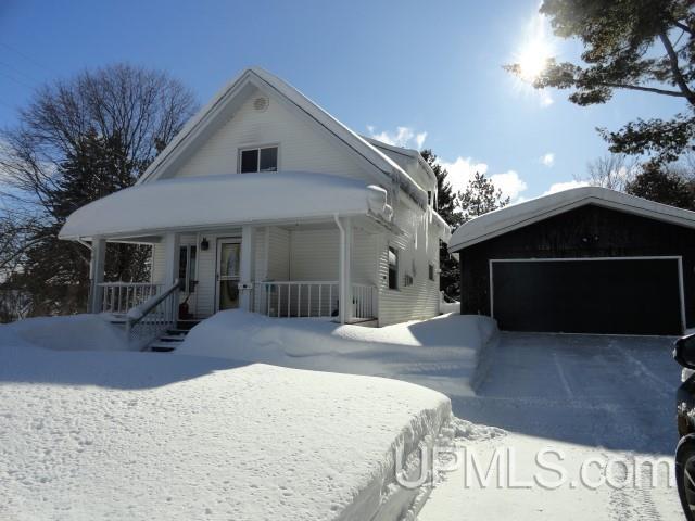 view of front of property featuring a garage and covered porch