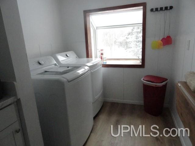 laundry room with separate washer and dryer and light wood-type flooring