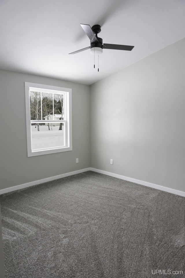 empty room with ceiling fan and carpet