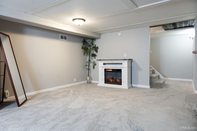 basement featuring light carpet