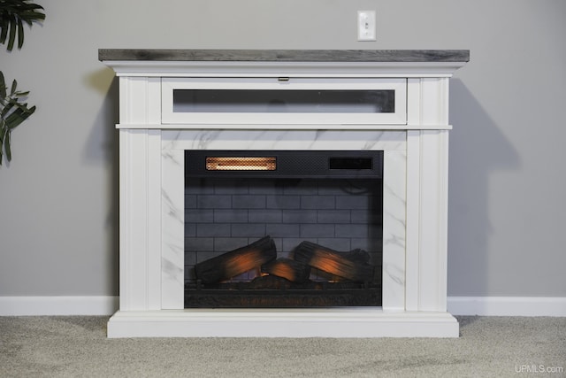 interior details featuring a fireplace and carpet