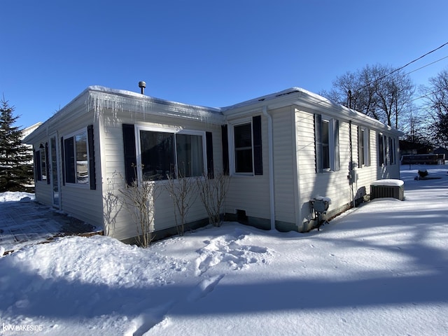 view of snow covered exterior with central air condition unit