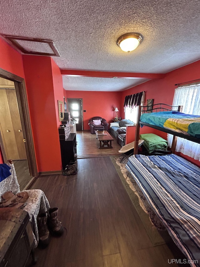 bedroom featuring dark wood-type flooring and a textured ceiling