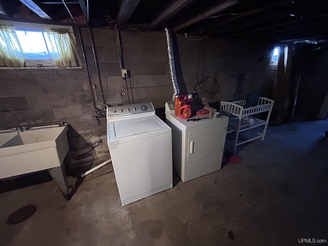 clothes washing area featuring sink and washing machine and dryer