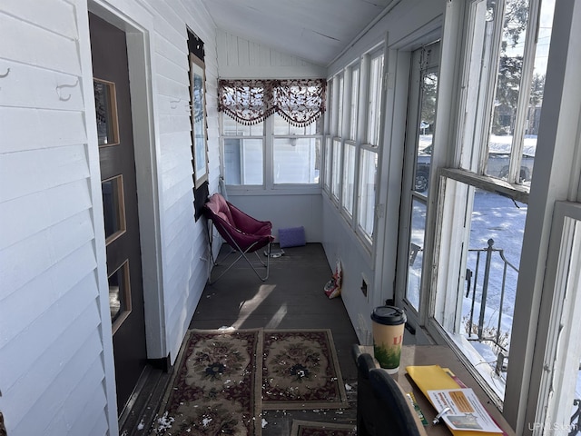 sunroom featuring vaulted ceiling and a wealth of natural light