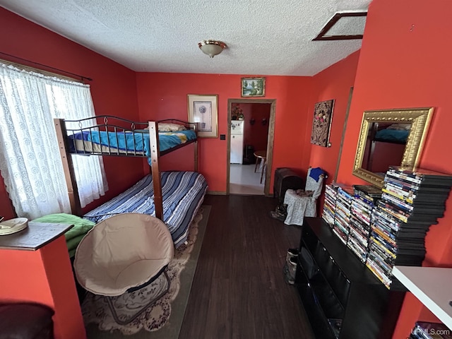 bedroom with dark hardwood / wood-style floors and a textured ceiling