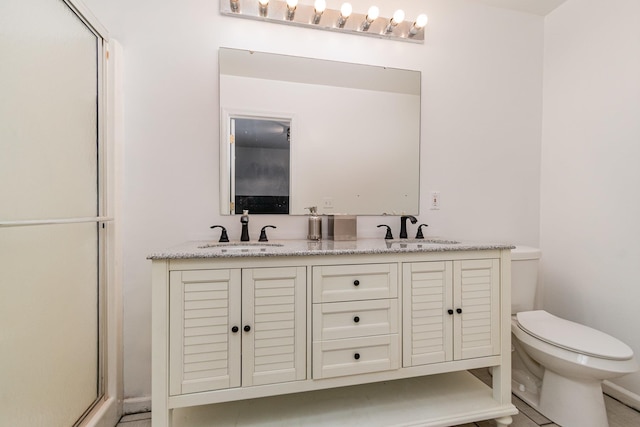 bathroom with vanity, toilet, and walk in shower