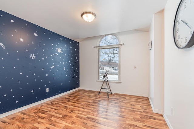 unfurnished room with wood-type flooring