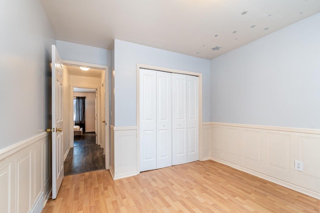 unfurnished bedroom featuring hardwood / wood-style floors and a closet