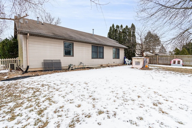 view of snow covered back of property