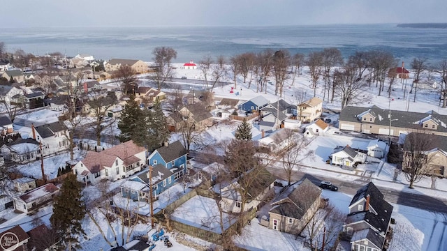 snowy aerial view with a water view