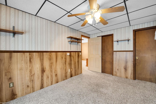 empty room featuring carpet, a paneled ceiling, and ceiling fan