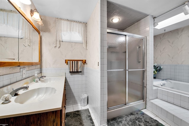 bathroom with vanity, tile patterned flooring, plus walk in shower, and tile walls