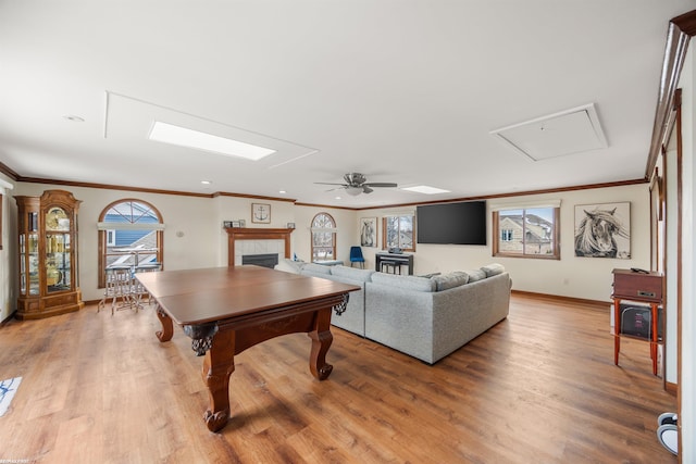 living room featuring ornamental molding, hardwood / wood-style floors, and a fireplace