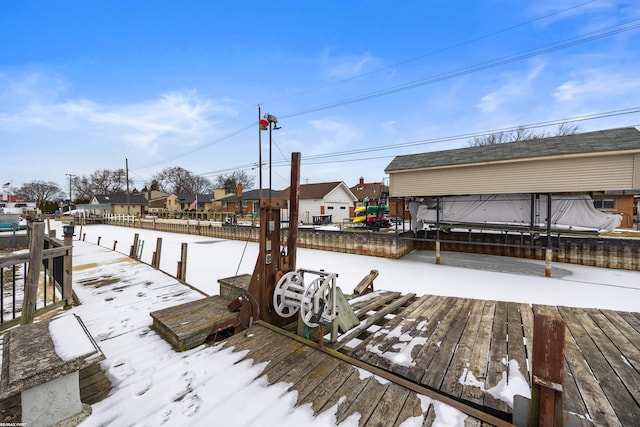 snow covered deck featuring a boat dock