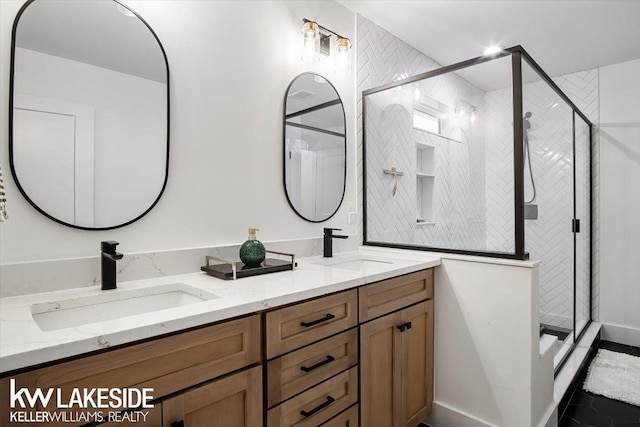 bathroom featuring vanity and a shower with door