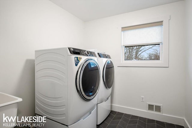 washroom with independent washer and dryer