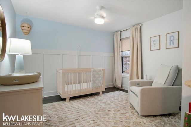 bedroom featuring a crib and hardwood / wood-style floors