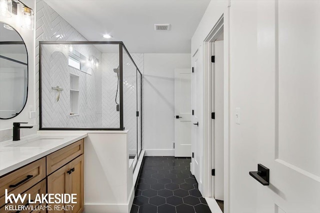 bathroom with vanity, tile patterned flooring, and a shower with shower door