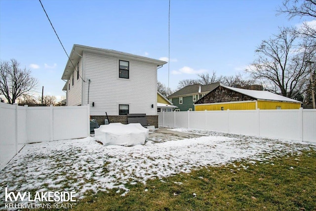 snow covered property with central AC