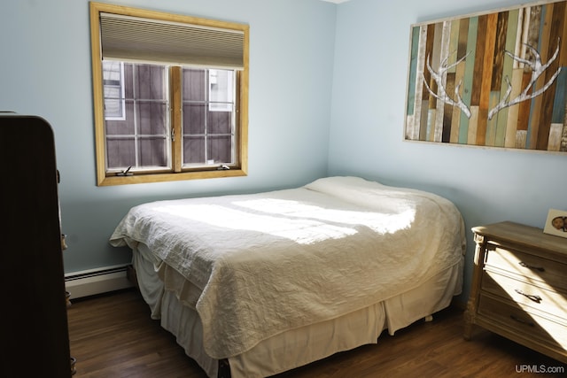 bedroom featuring dark hardwood / wood-style flooring and a baseboard heating unit