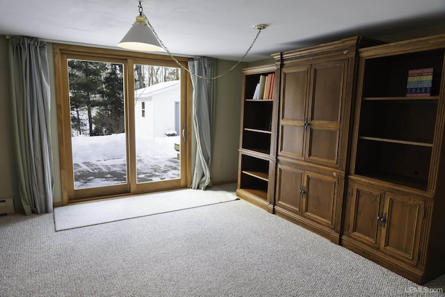 entryway featuring baseboard heating and carpet flooring