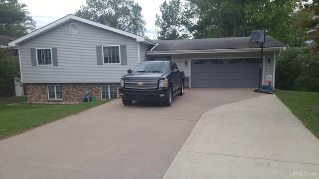 view of front of home with a garage and a front lawn