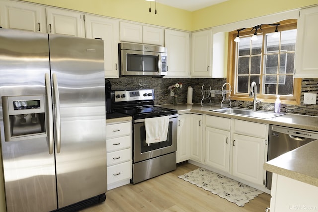 kitchen with white cabinetry, sink, and appliances with stainless steel finishes