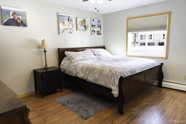 bedroom with ceiling fan, a baseboard radiator, and dark hardwood / wood-style floors