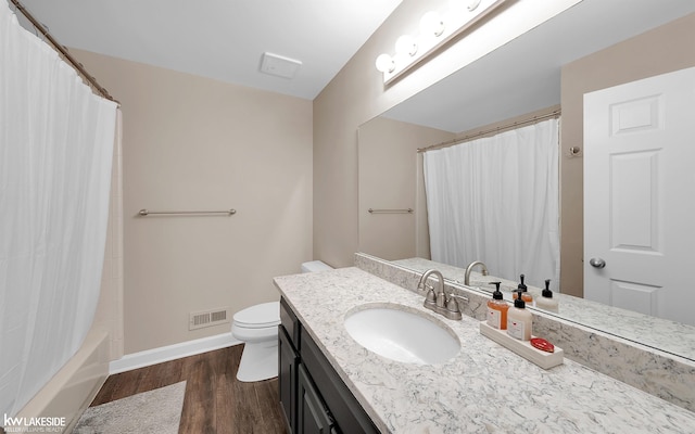 full bathroom featuring shower / tub combo with curtain, wood-type flooring, toilet, and vanity