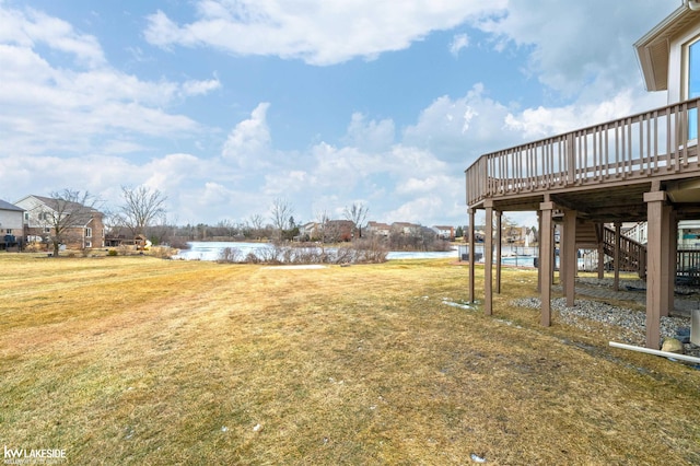 view of yard with a deck with water view