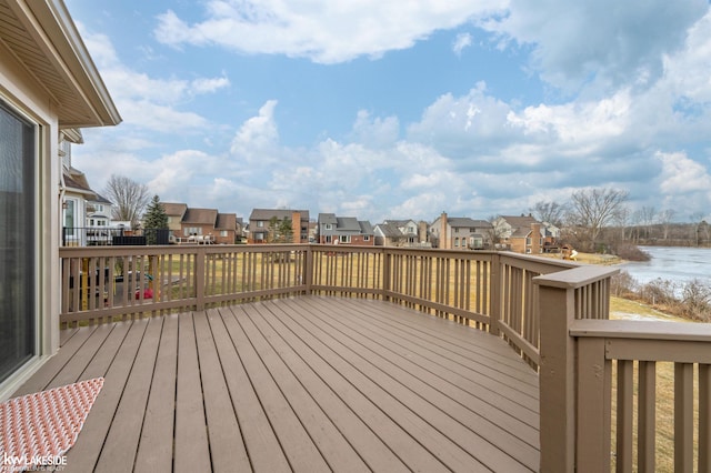 wooden terrace featuring a water view