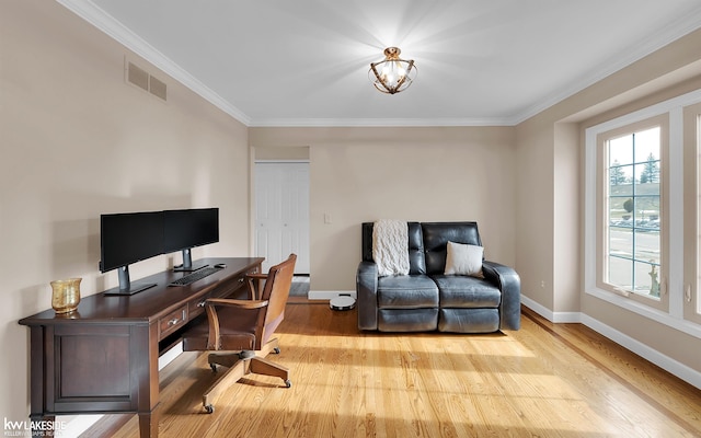 office space with crown molding and light hardwood / wood-style flooring