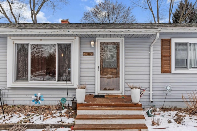 view of snow covered property entrance