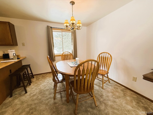 dining area featuring a chandelier and carpet