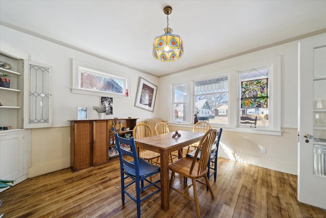 dining room featuring wood-type flooring and ornamental molding