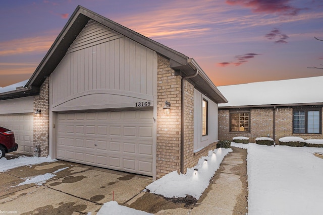 view of snow covered exterior with a garage